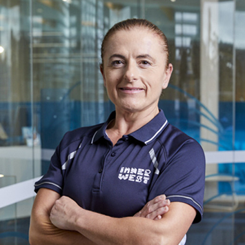  Personal trainer Rosetta Ferraro smiling with arms folded in front of chest